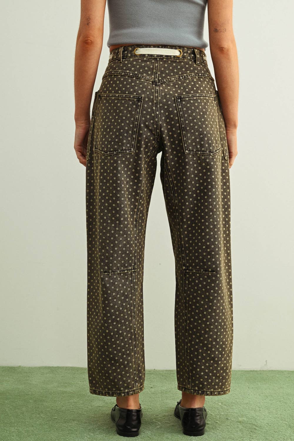 Person wearing patterned pants on a plain background