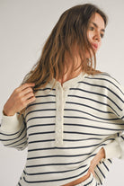 closeup view of woman wearing black and white striped, half button cozy warm and stylish design