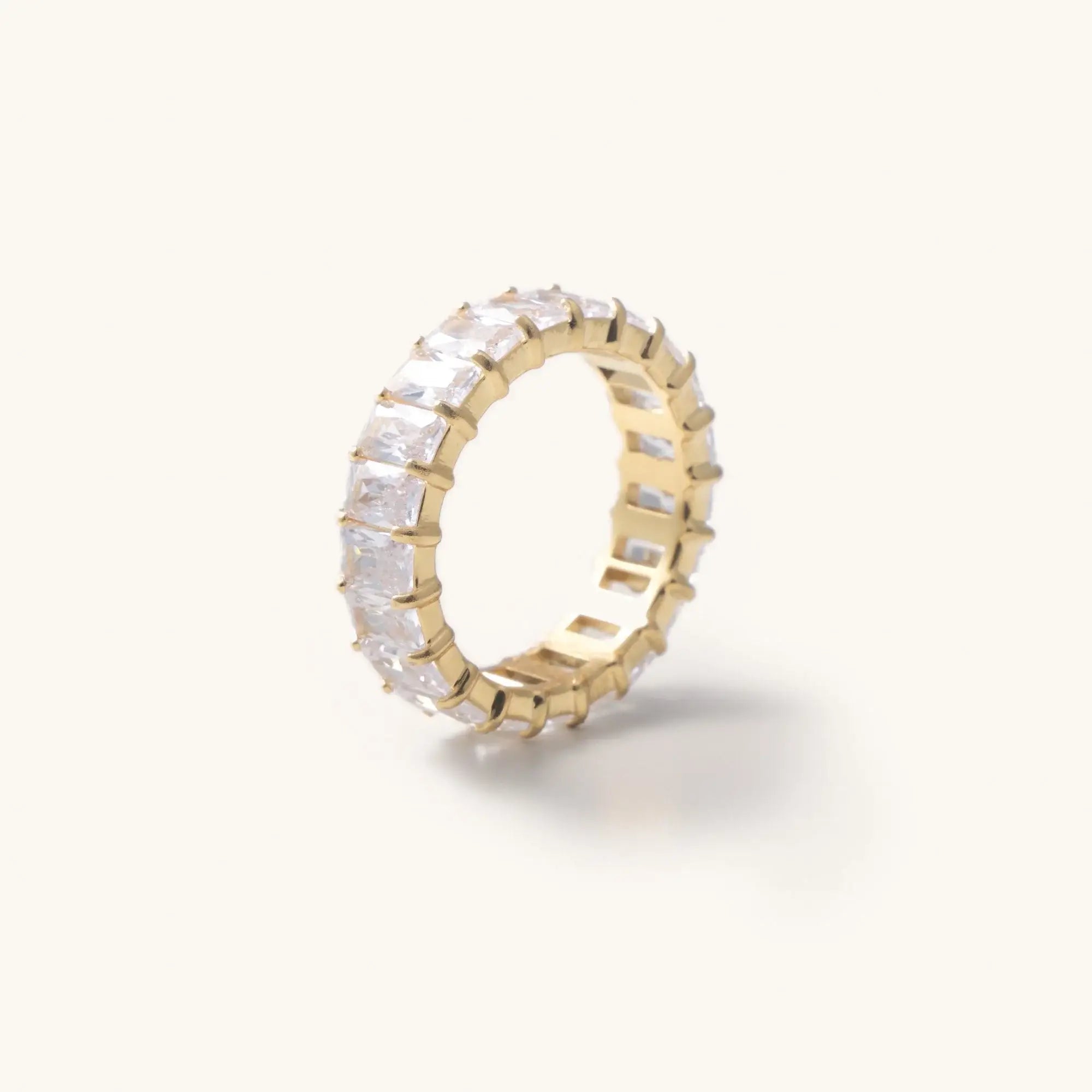 Waterproof gold crystal Cubic zirconia ring laying in a white background 