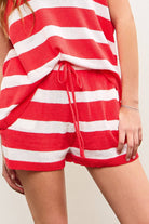 Woman wearing red and white horizontally striped waist sweater shorts with red drawstring tie 