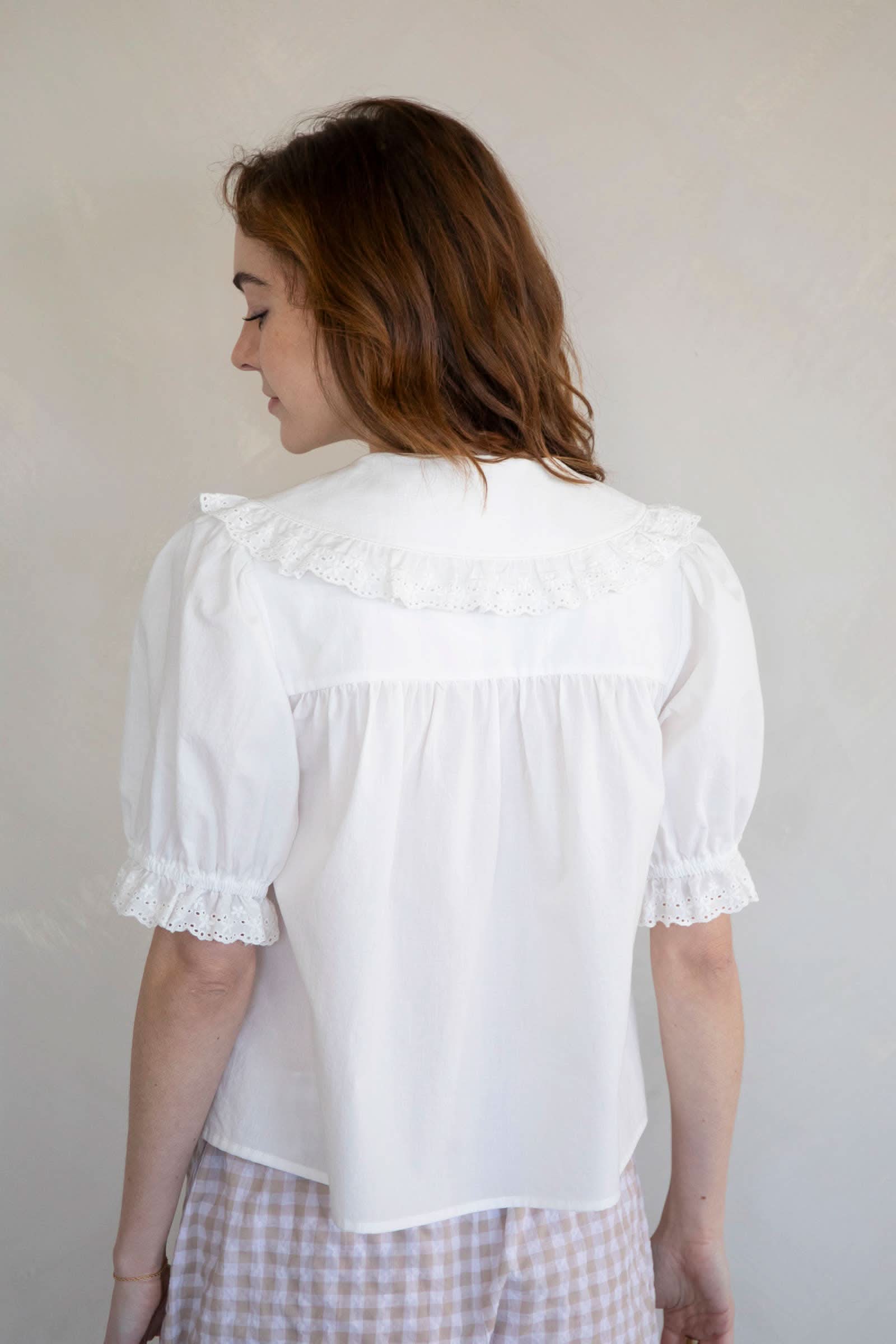 Woman wearing white embroidered collared and half button dreamy sweetheart blouse