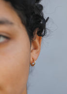 woman wearing double hoop gold earring set