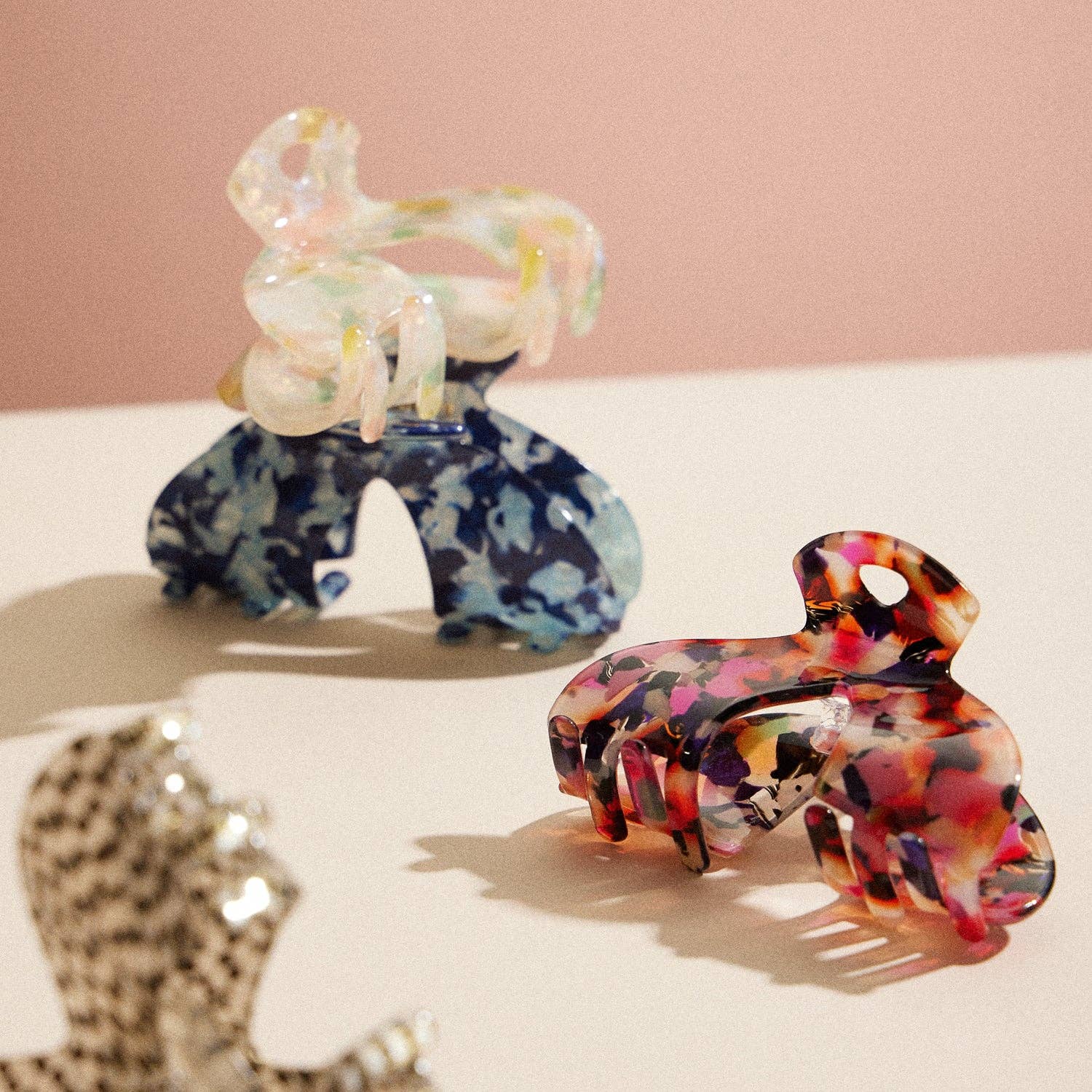 Four hair claw in different colors including multicolor, natural; blue, black and white 