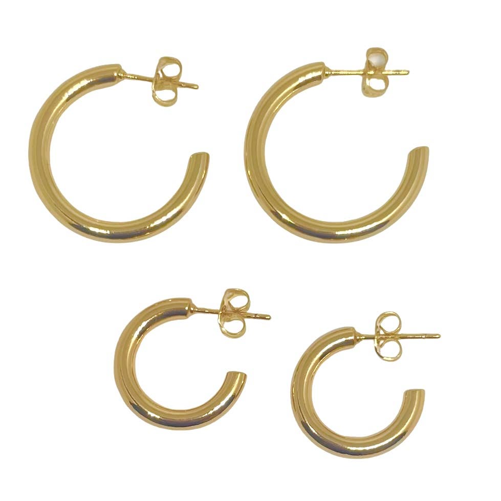  gold medium sized tube hoop earrings laying on a white background 