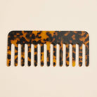 Dark brown tortoise comb laying flat on white background