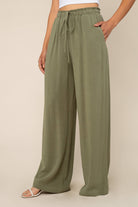 Woman wearing Sage green, wide leg, cove linen pant and white tee