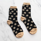 black socks with tan doodled flowers and accents 