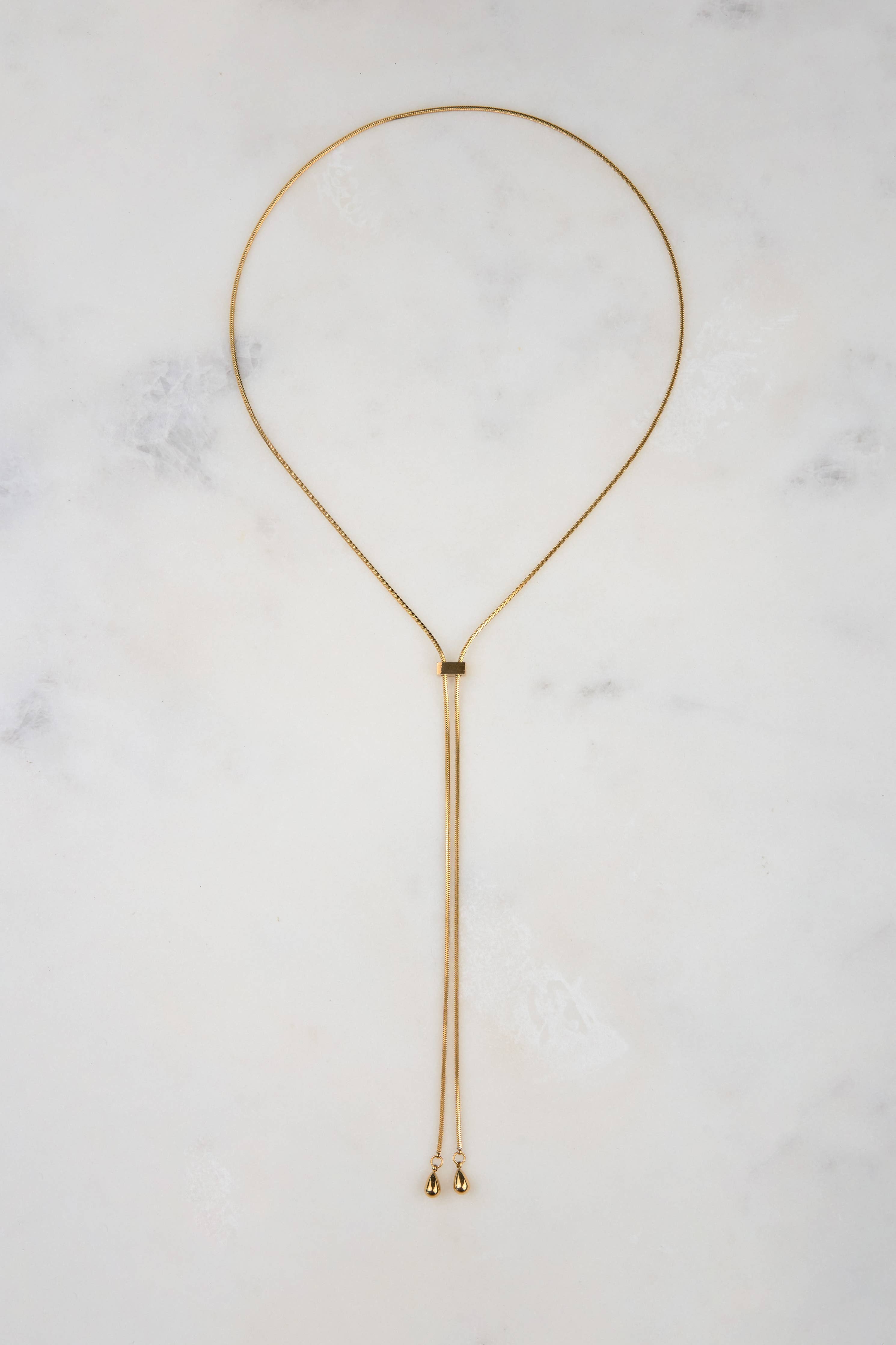 Gold necklace on a marble surface