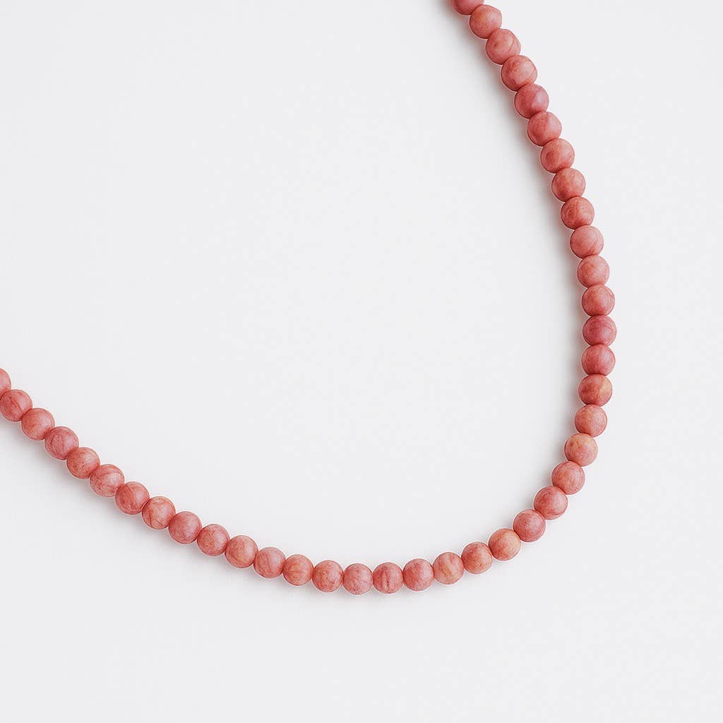 Necklace with pink beads on a white background