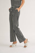 woman posing wearing Textured vertical Stripe Knitted Pants with contrasting stripes in the front pockets made of 100% Cotton