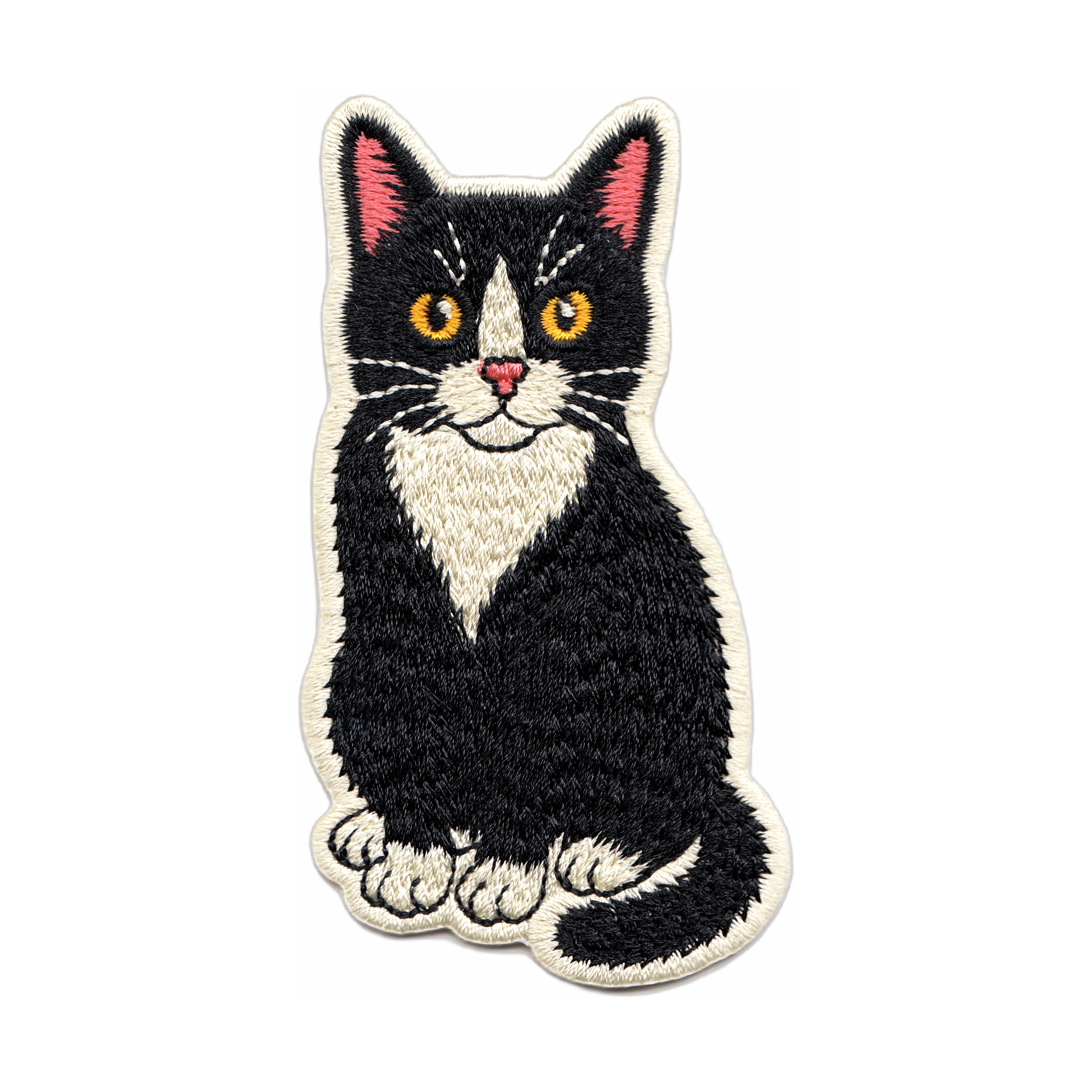Embroidered patch of a black and white cat on a white background