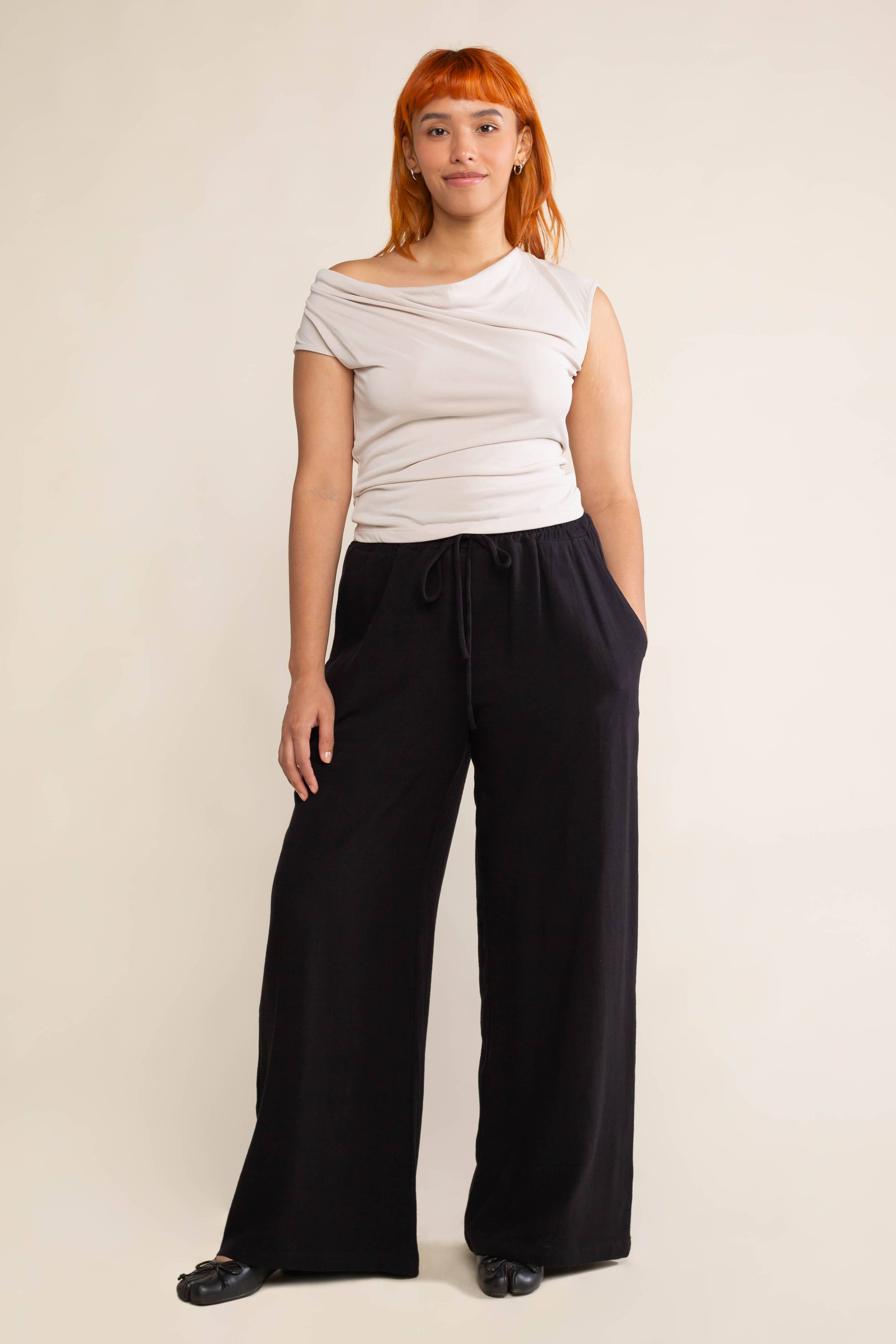 Woman wearing black, wide leg, cove linen pant and white tee