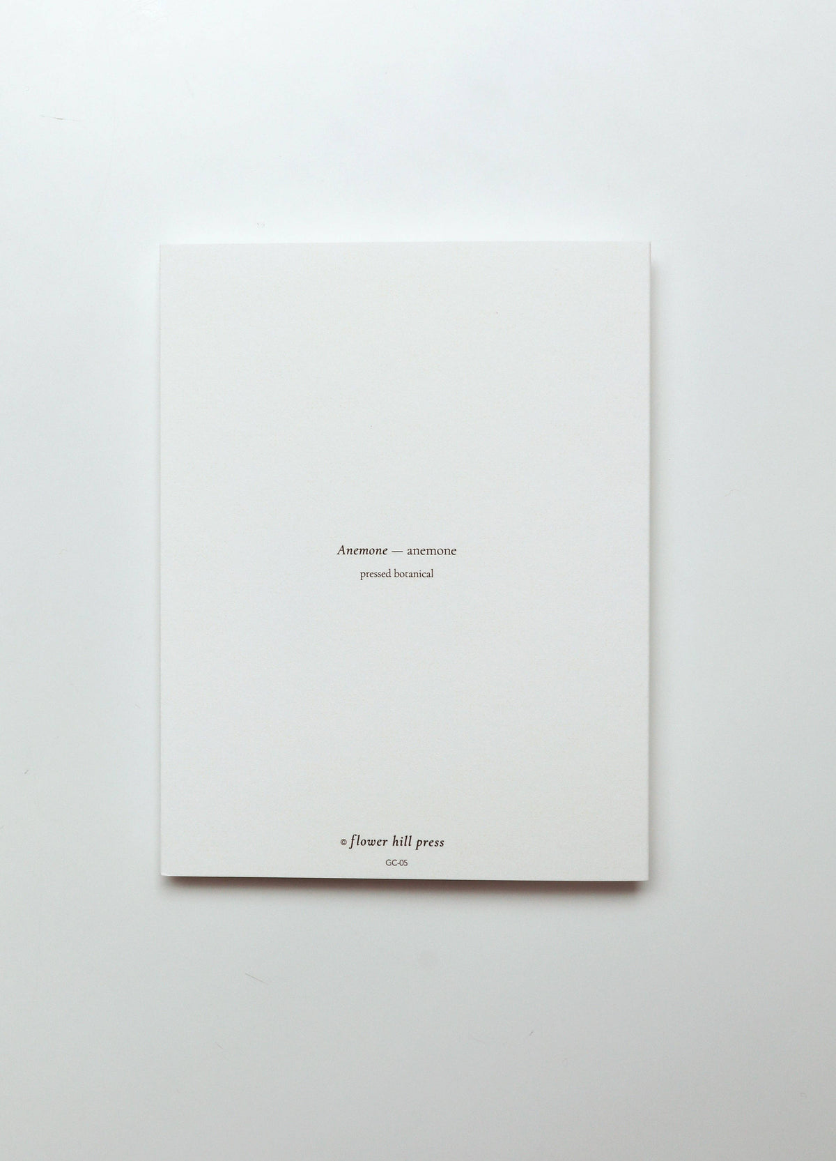 A minimalist white art print or booklet from A Flower Kill Press, featuring small black text centered on a clean white background.