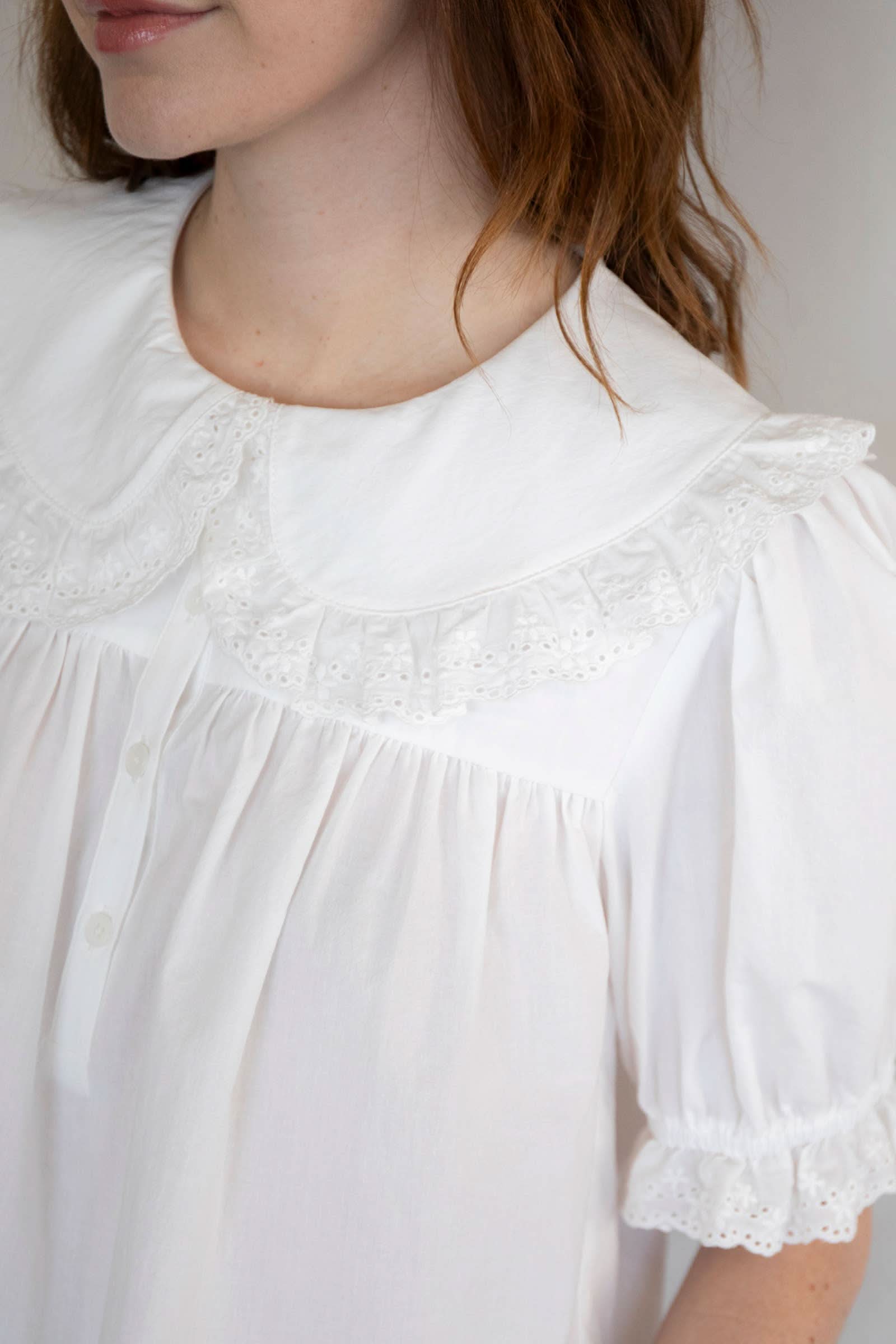 Close up on Woman wearing white collared and half button dreamy sweetheart blouse