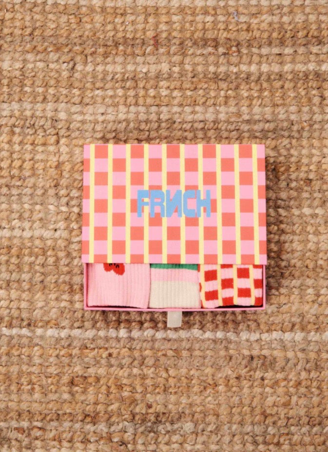 Checkered pouch with 'FRENCH' text on a textured surface