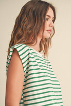 model wearing green and white striped cotton short sleeve top with a structured shoulders