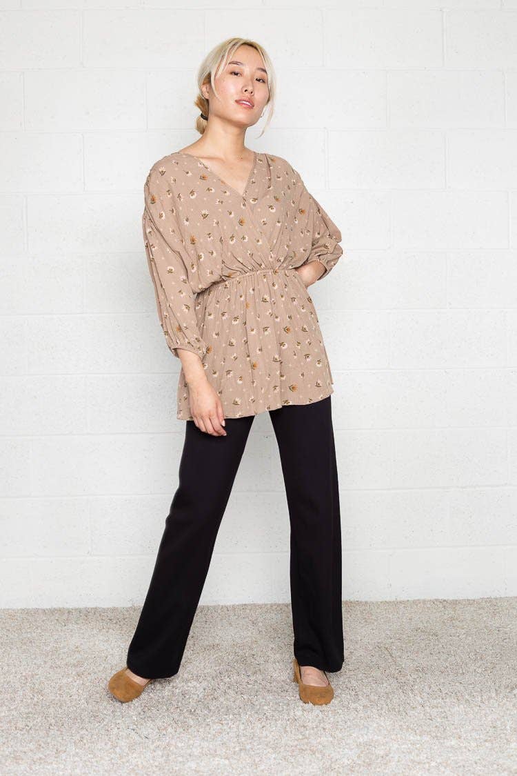Woman wearing flats and black Micah pants that are skinny on the top with wide bottom