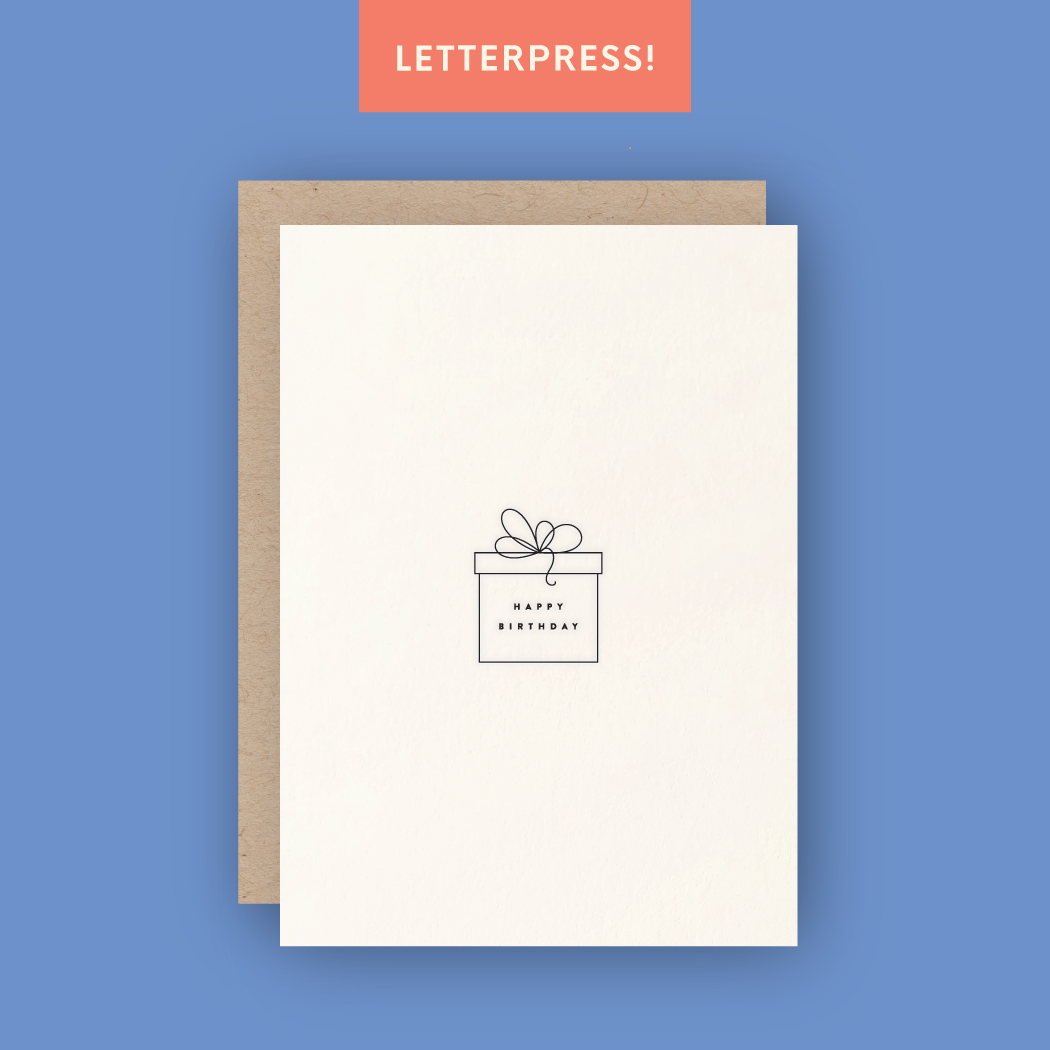 Happy birthday greeting card picturing black thin present box with ribbons