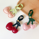 Three Cherry bag charms- leather heart shaped cherries with leaf and looped stem and gold button clasp to use as bag charm