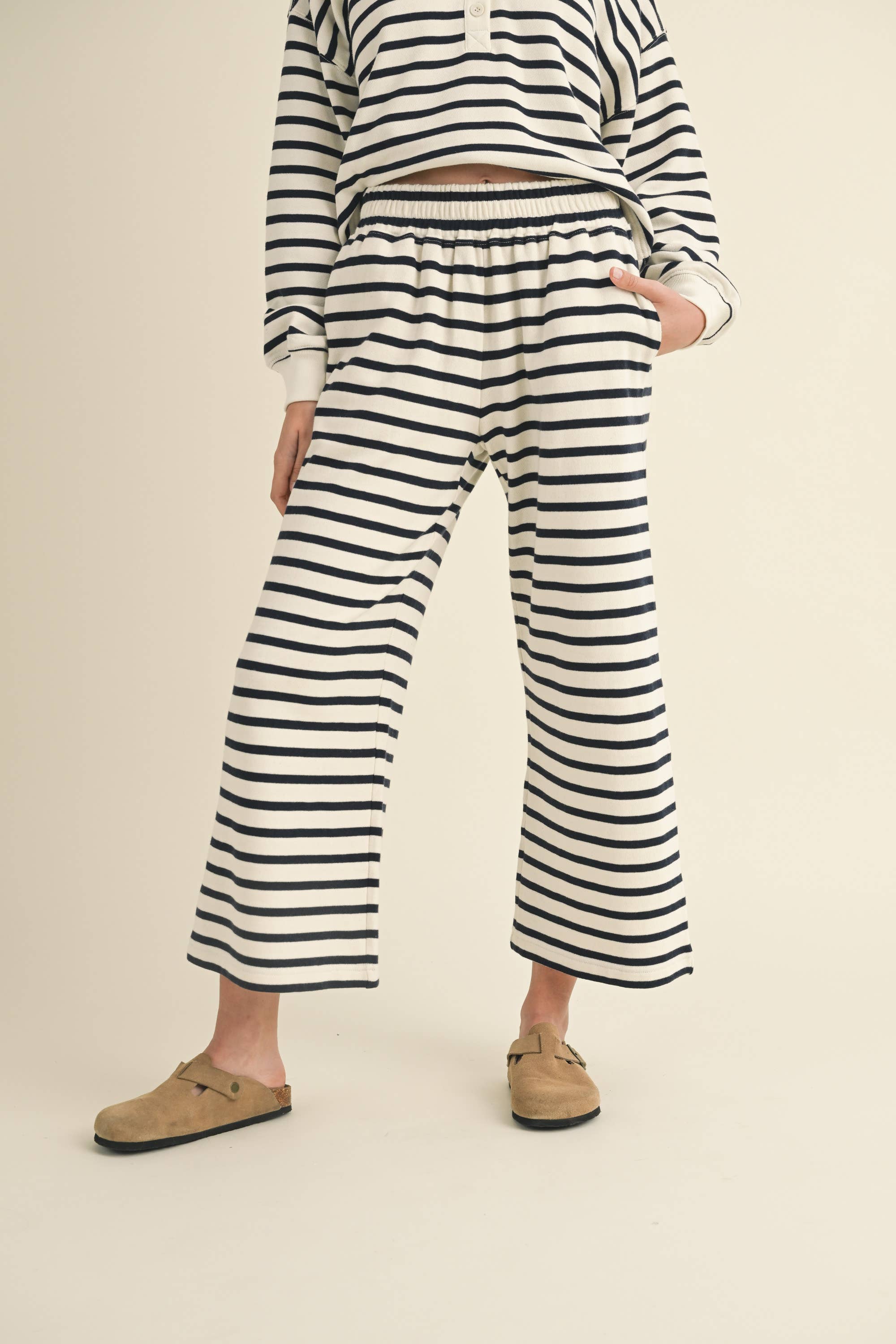 woman wearing white and black striped casual everyday pants 