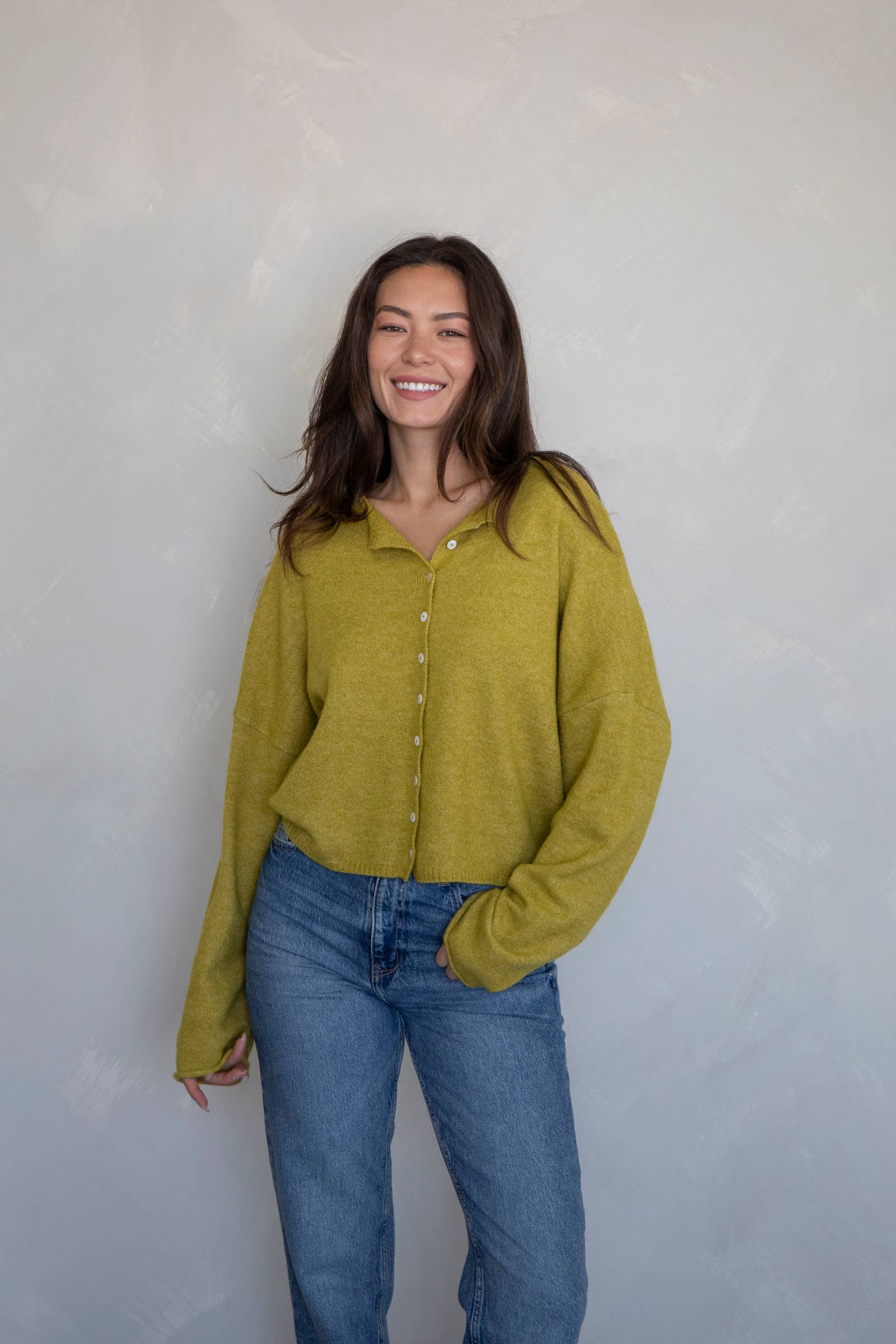 model wearing unique green button up cardigan 