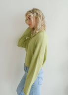 Woman with blonde hair turned to side wearing long sleeve lemongrass cardigan 