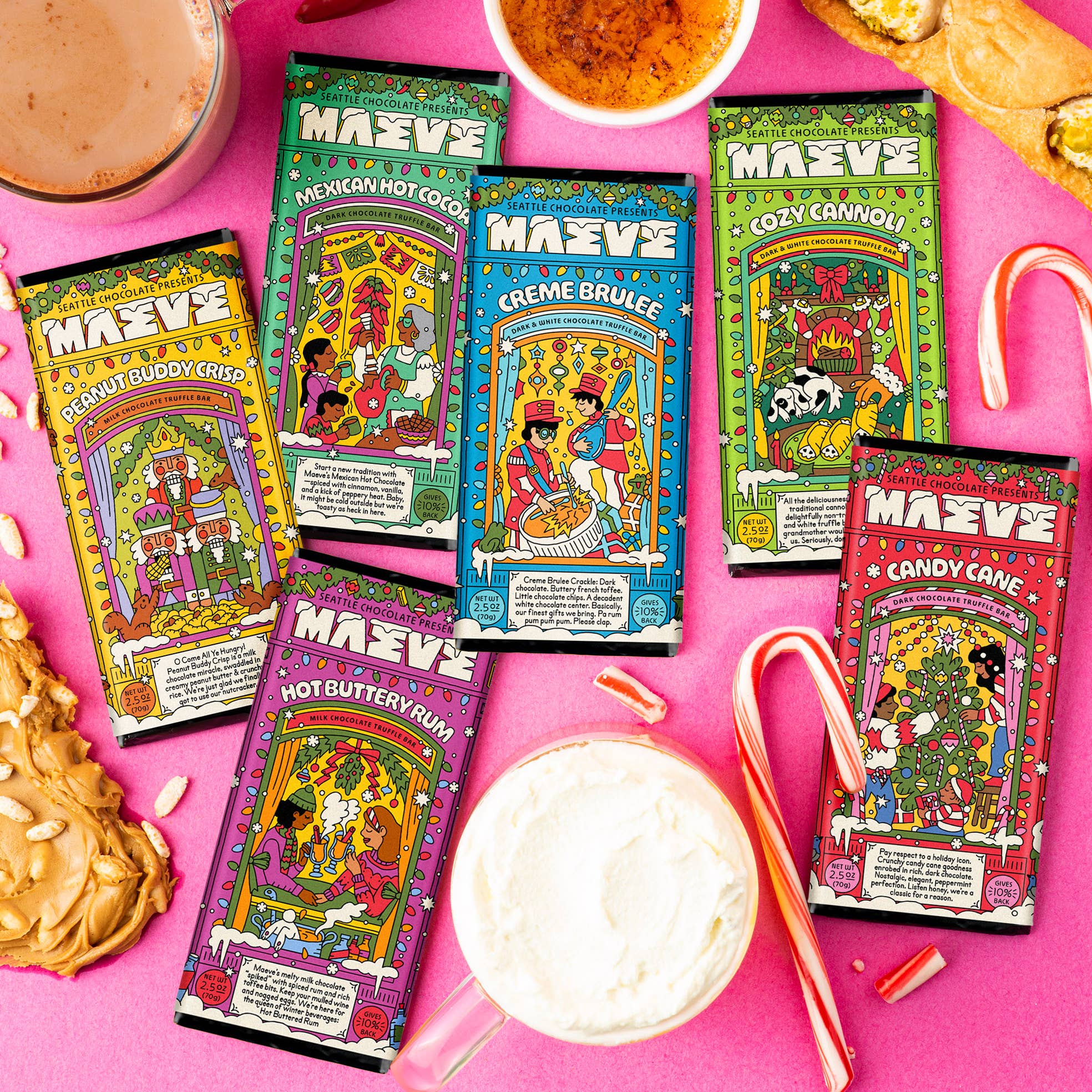 Colorful packages of MAVEE hot chocolate on a pink background with candy canes and cookies.