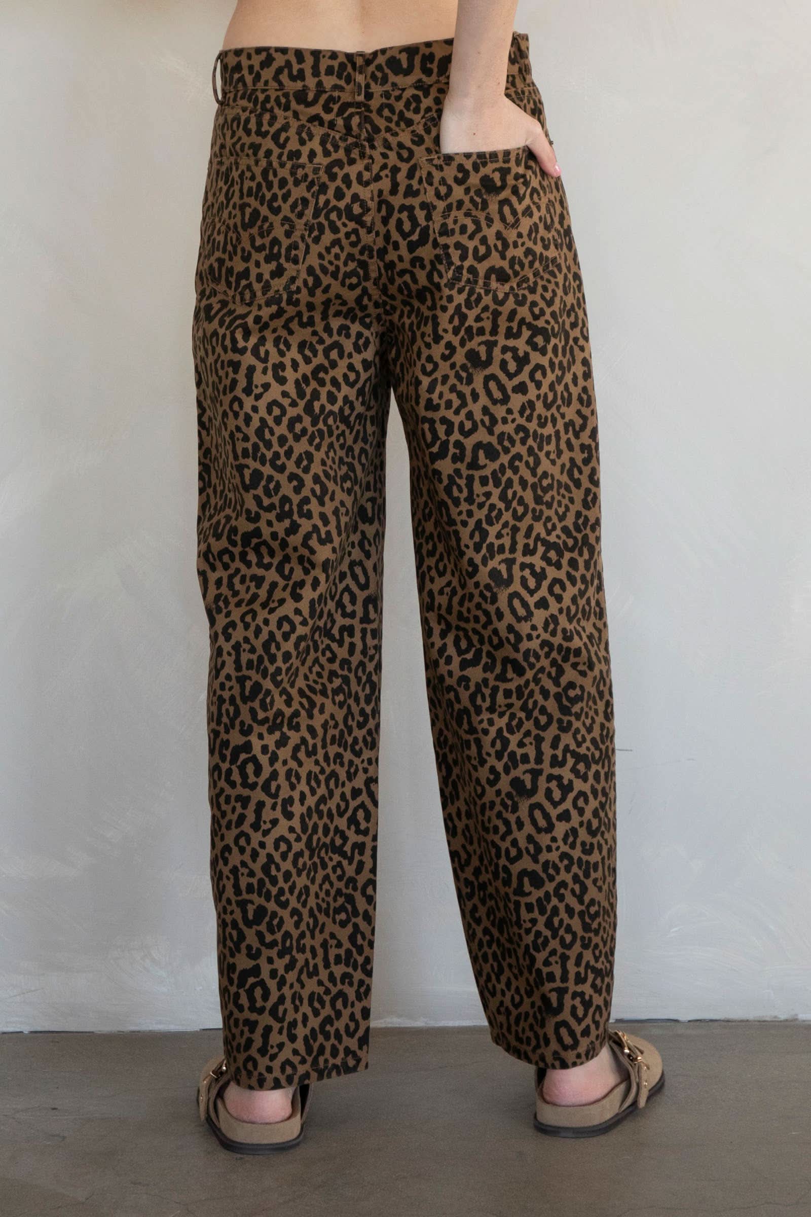 Leopard print pants worn by a person against a plain background