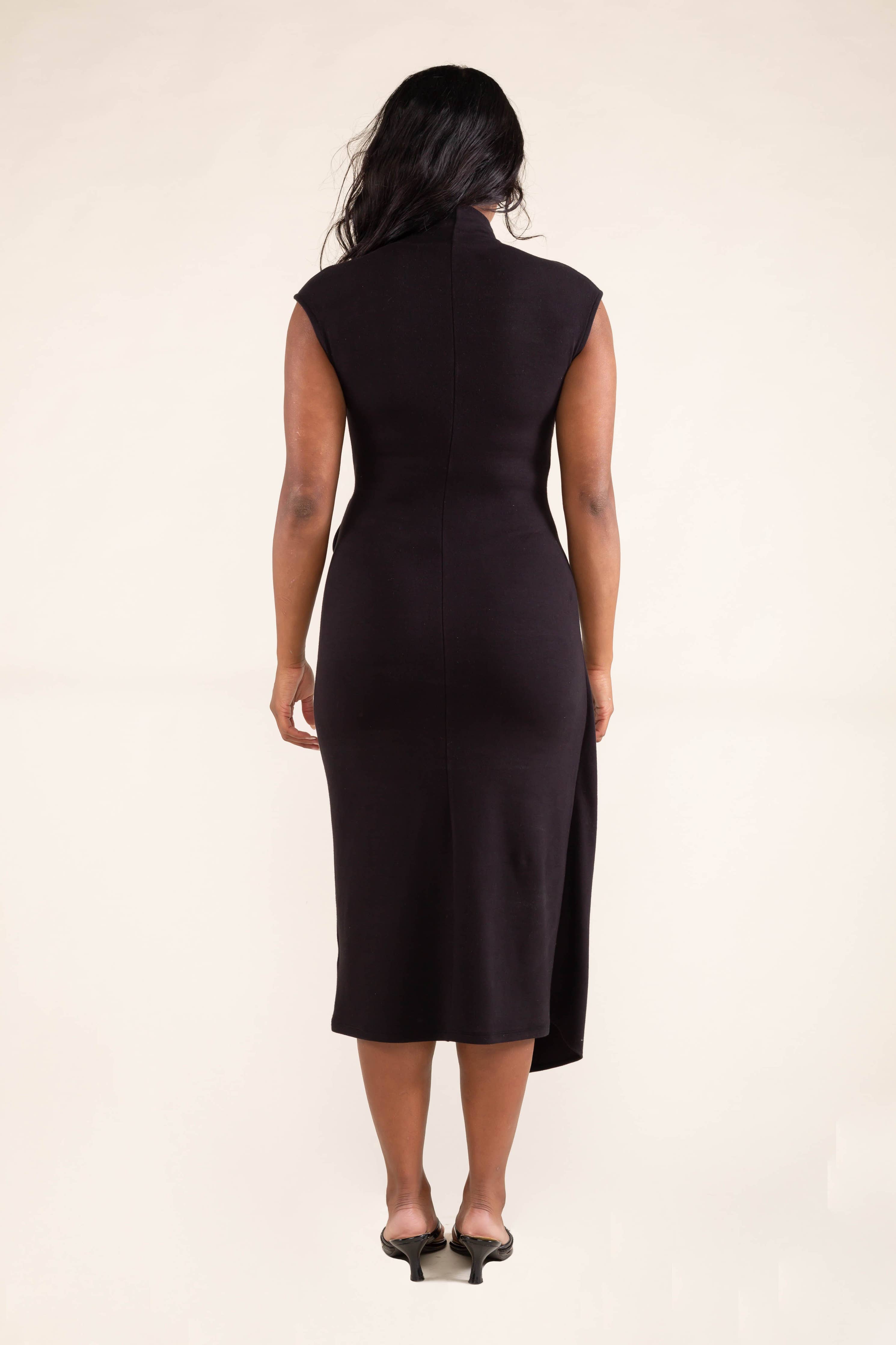 Woman wearing black, Mock neck, midi dress with off shoulder sleeves with front tie skirt detail.