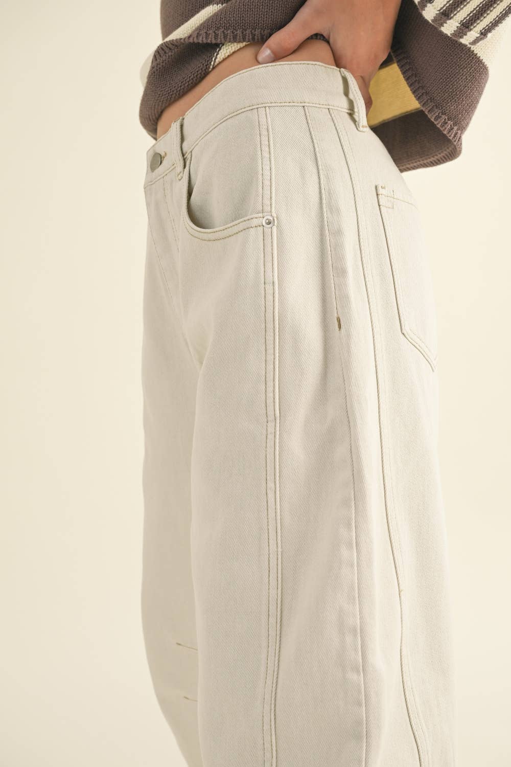 Beige pants worn by a person on a beige background