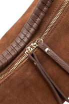 Close up details of Chestnut brown, real suede bag with gold embellished details and multiple strap options 