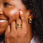 Woman wearing Beautiful mixed metal silver and gold stacked four ring set 