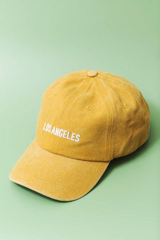 Yellow cap with 'Los Angeles' text on a green background