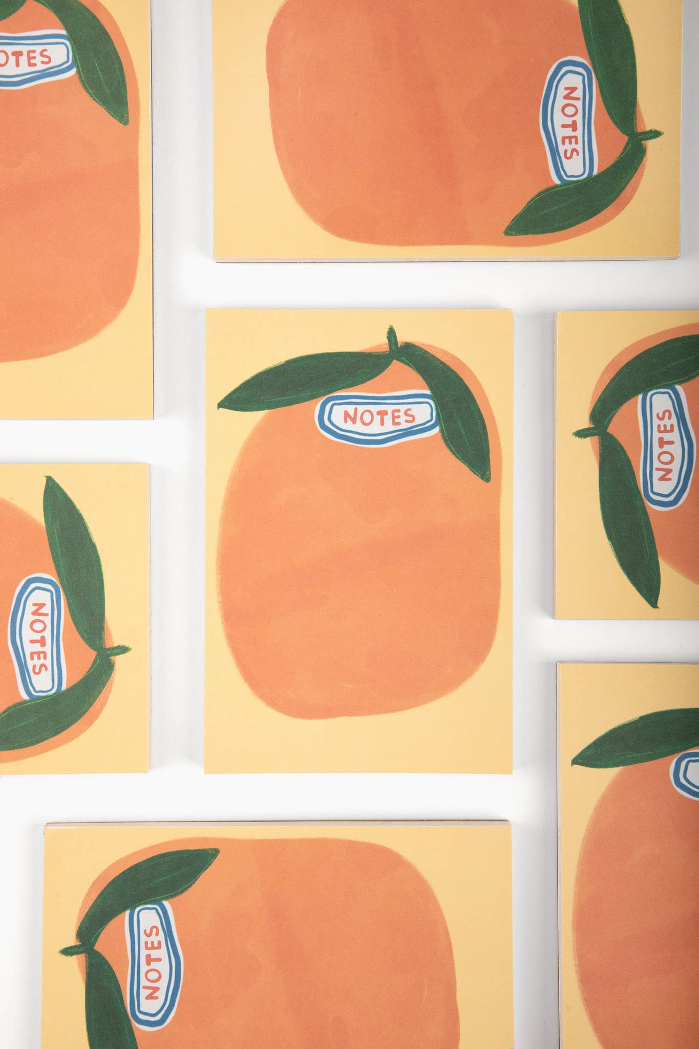 Notebooks with peach design and 'NOTES' label on a white background