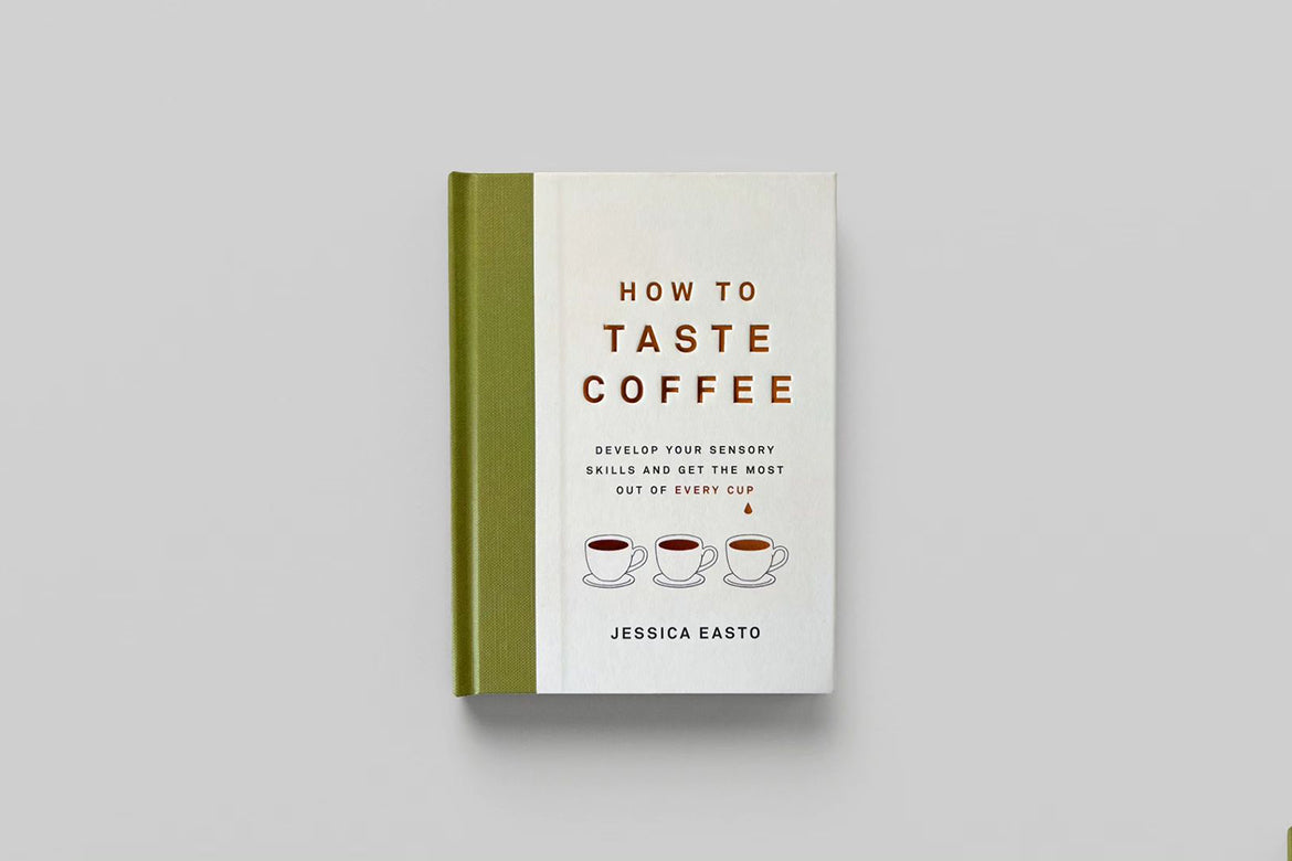 Book laying on surface titled How To Taste Coffee 