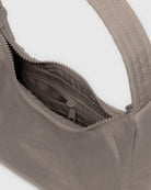 inside details of nylon BAGGU adjustable nylon shoulder bag witting on a white background wearing