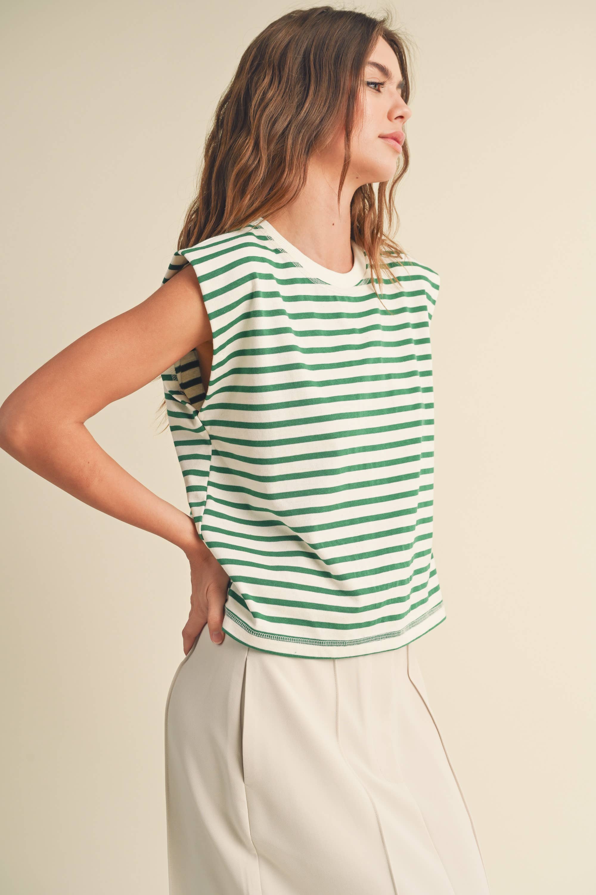 model wearing green and white striped cotton short sleeve top with a structured shoulders