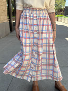 Woman wearing cream skirt with 