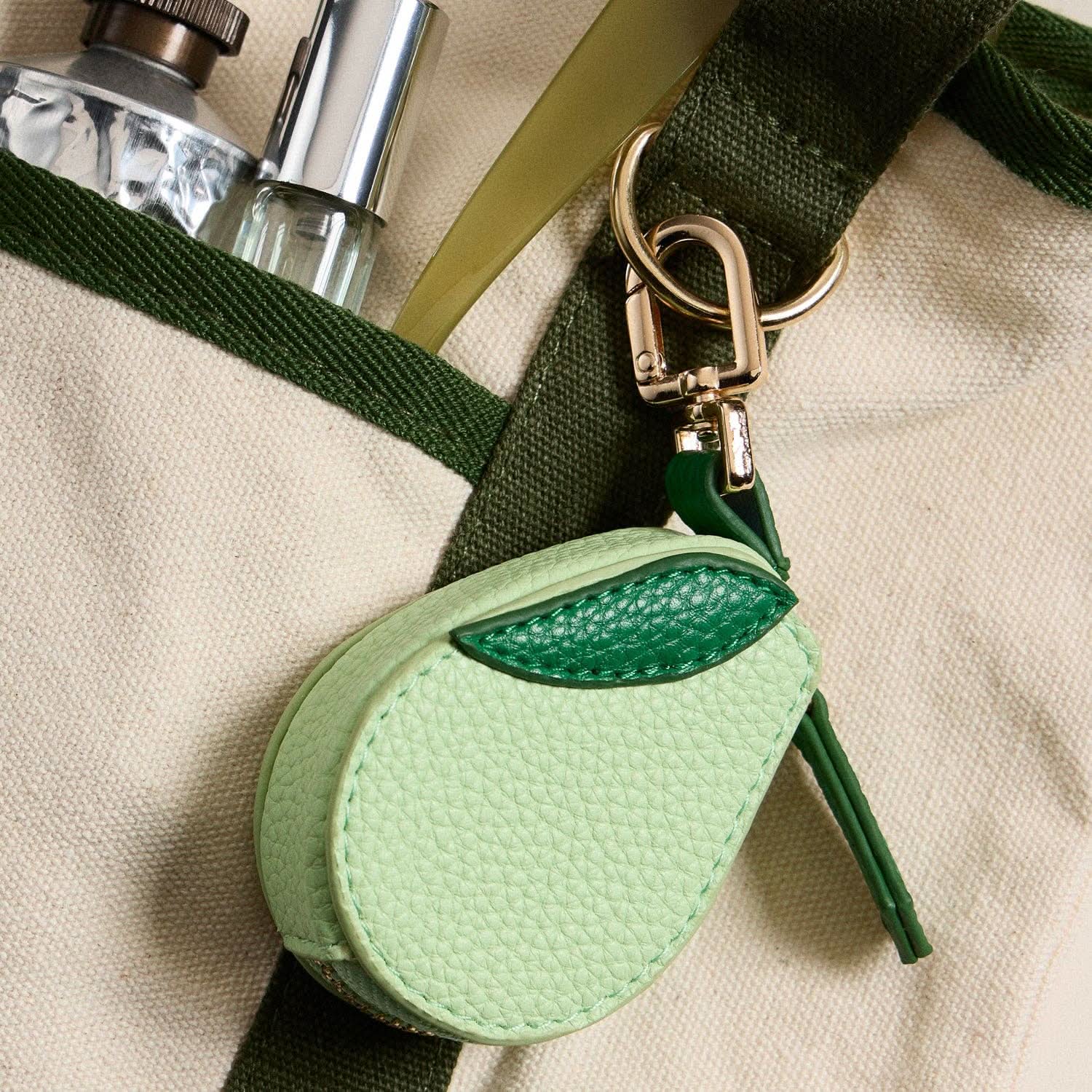 Textured light green avocado-shaped coin purse and a gold-tone