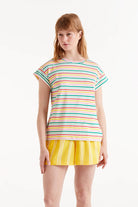 Woman wearing multi-stripe stripped t-shirt and yellow shorts 