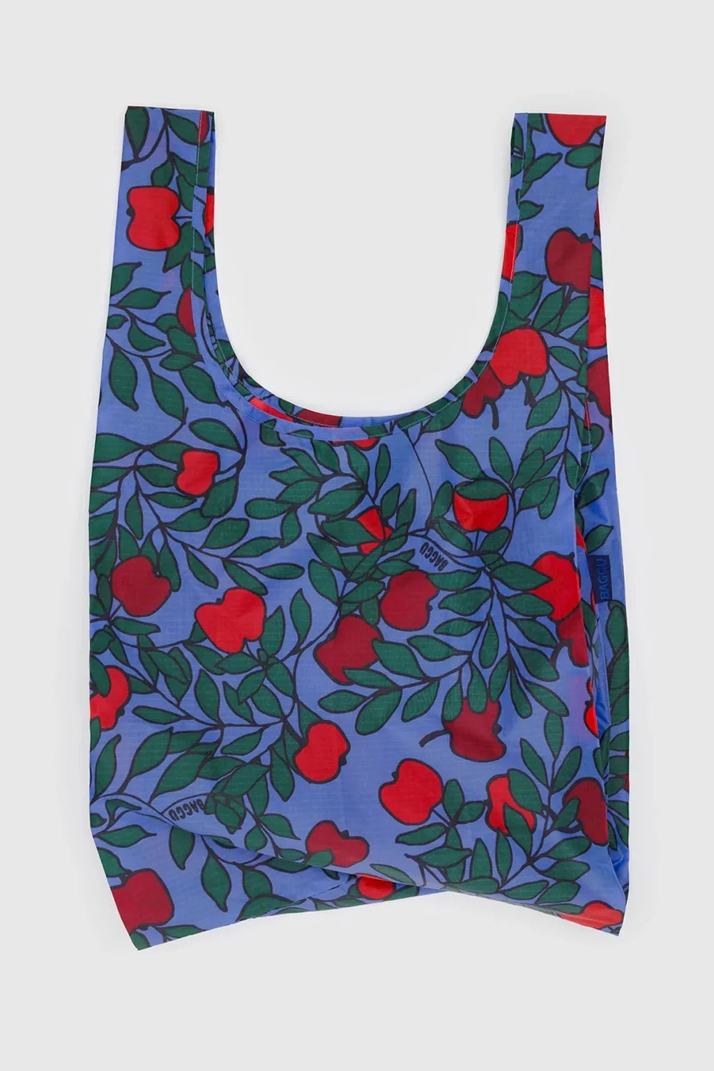 Reusable bag with red apple and green leaves pattern on a purple background