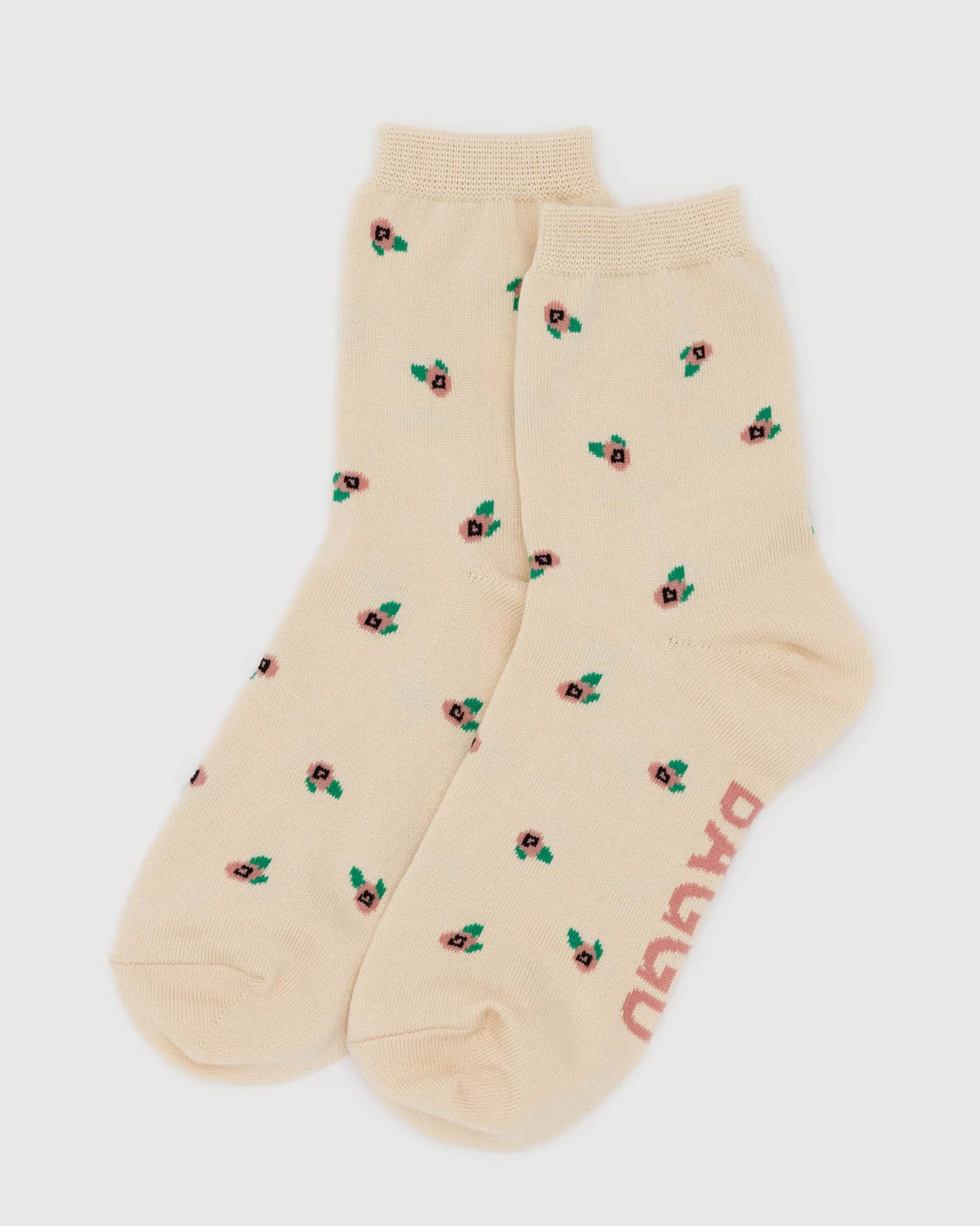 Beige socks with floral patterns and 'Puma' branding on a white background