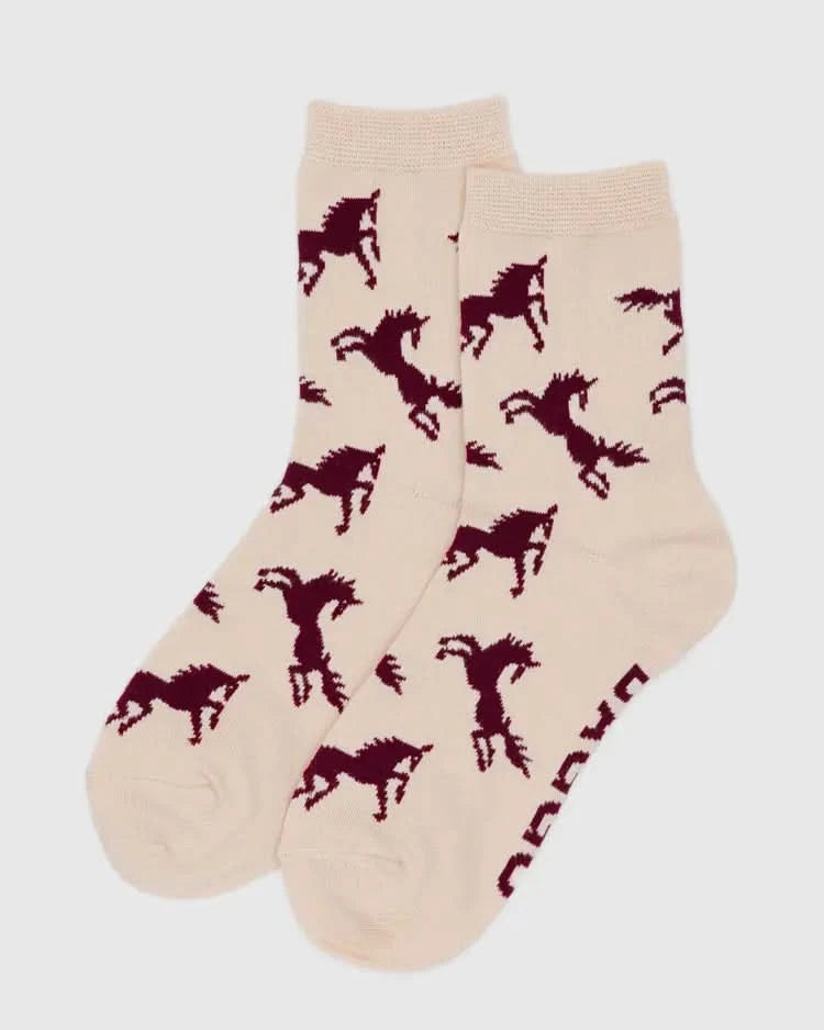 Beige socks with red horse patterns on a light gray background