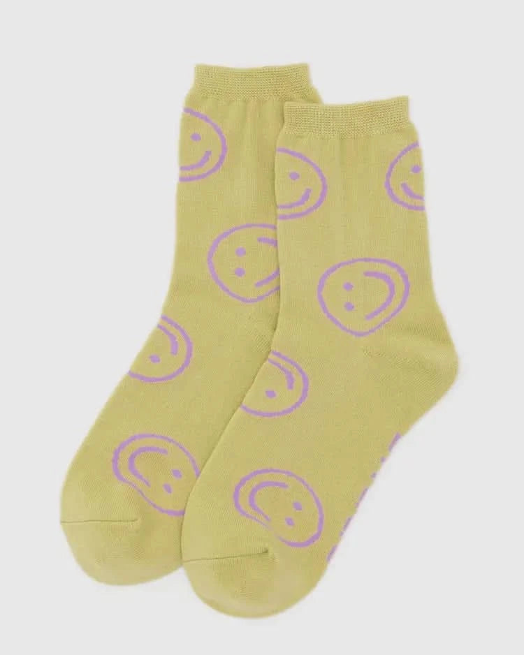 Yellow socks with purple smiley face patterns on a white background