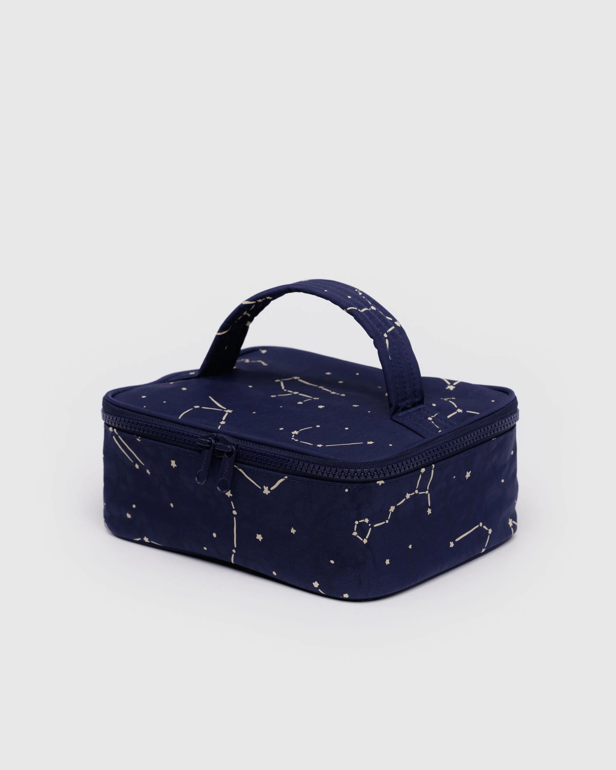 Navy blue cosmetic bag with star pattern on a light gray background