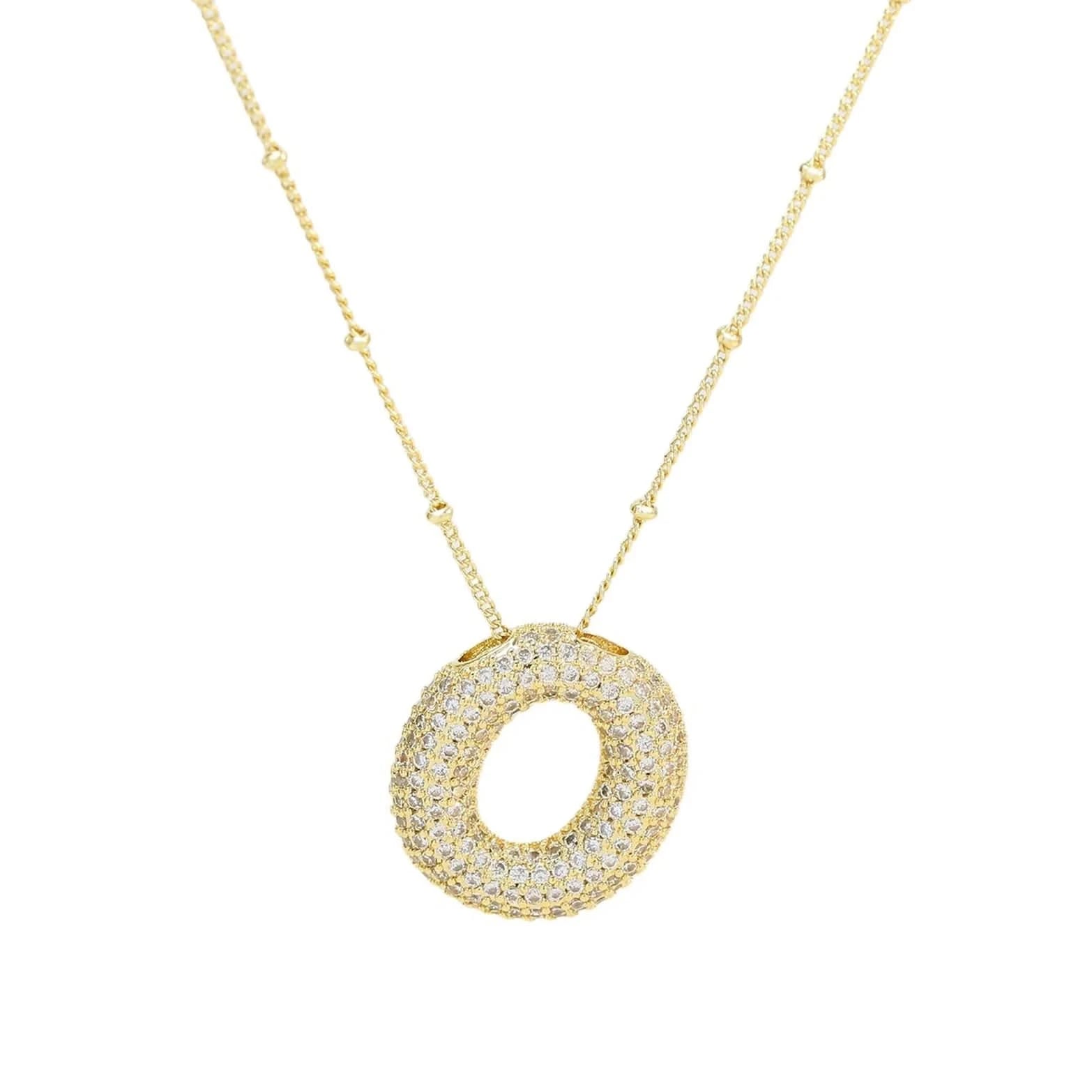 Gold necklace with a circular pendant on a white background