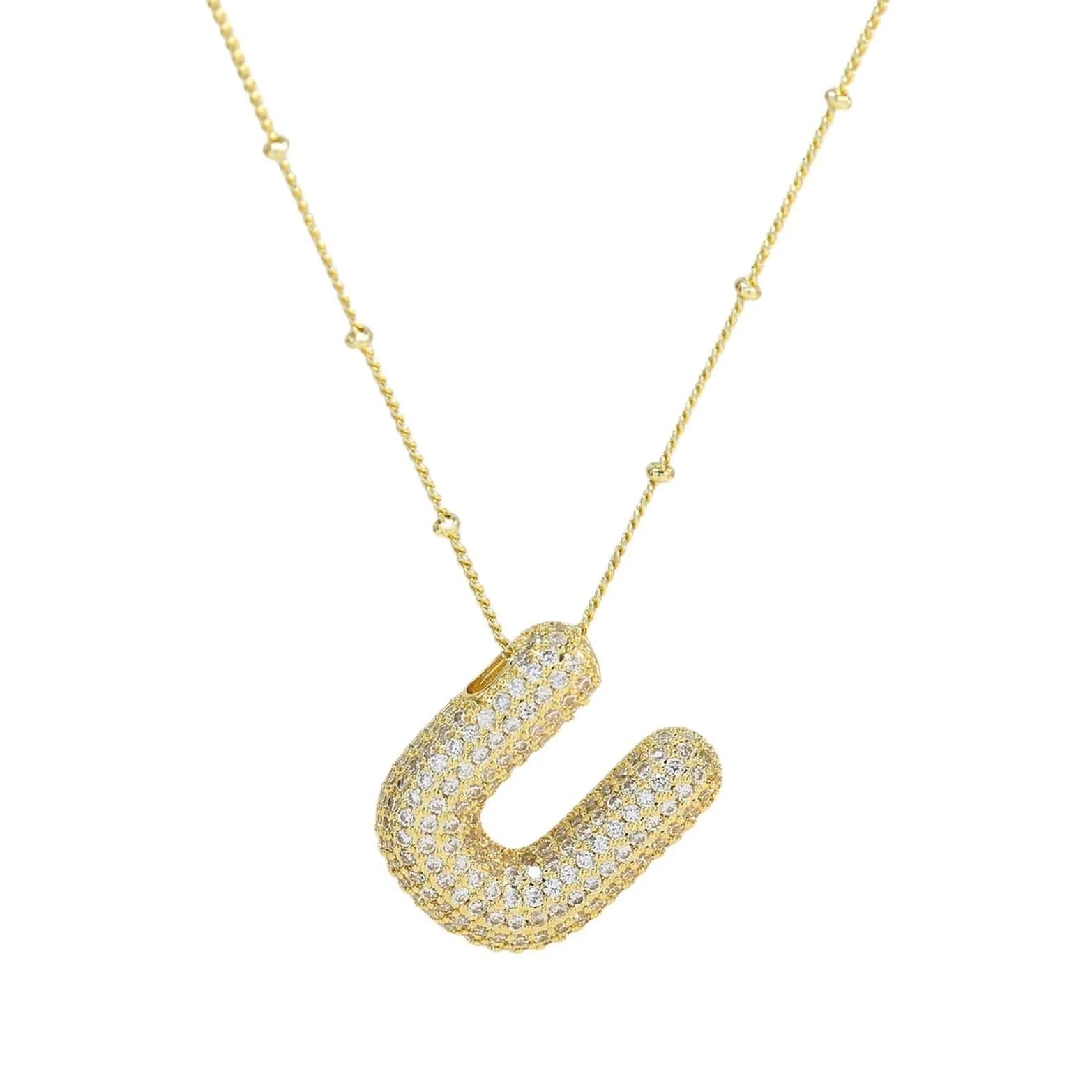 Gold necklace with a U-shaped pendant on a white background