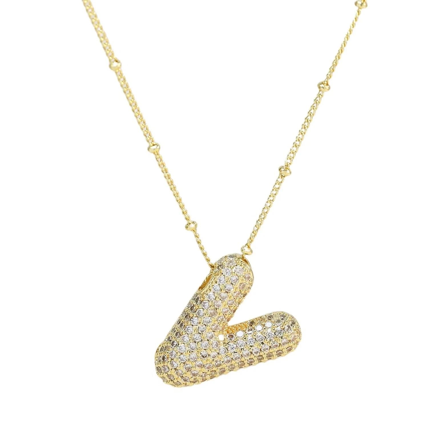 Gold necklace with a V-shaped pendant on a white background