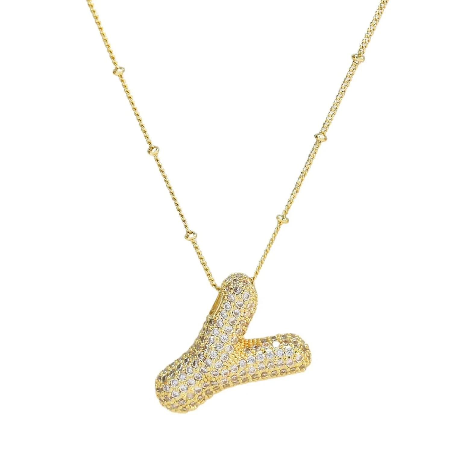 Gold necklace with a unique pendant on a white background