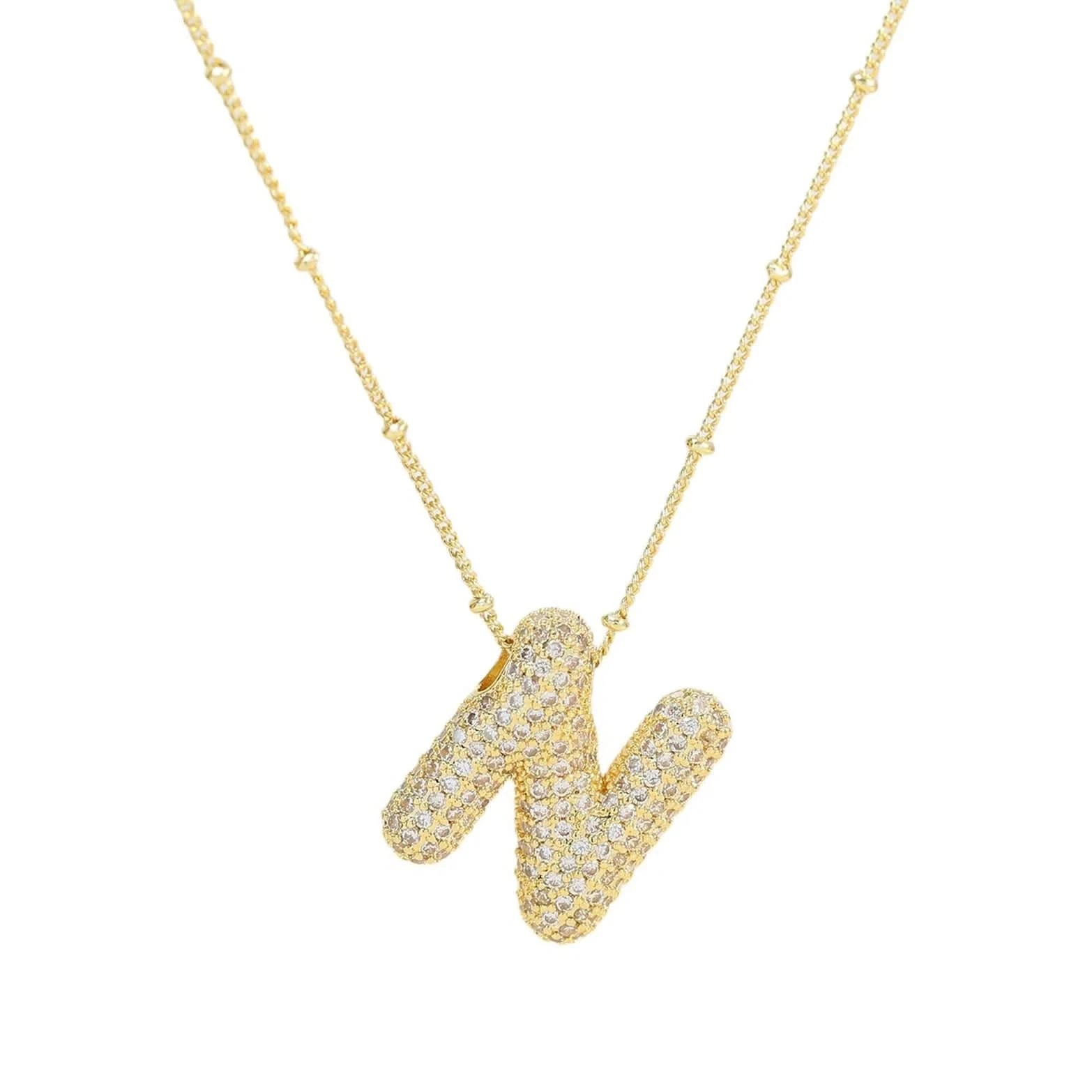 Gold necklace with a letter 'N' pendant 